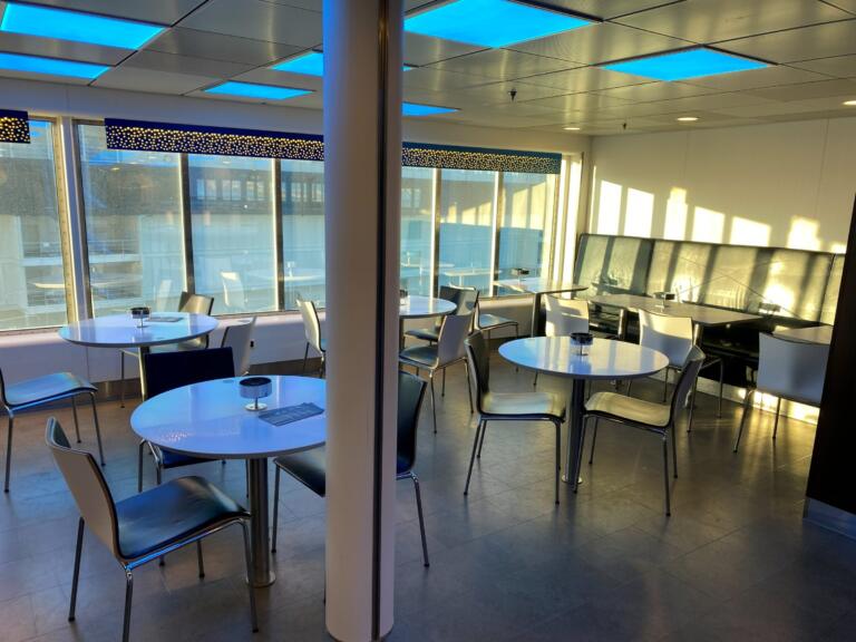 Lounge with tables and panorama windows on the ferry