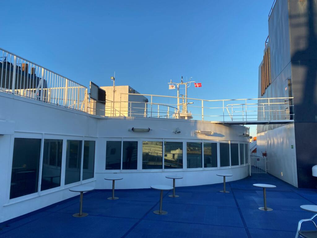 Tables on the sun deck and the lounge windows of the ferry